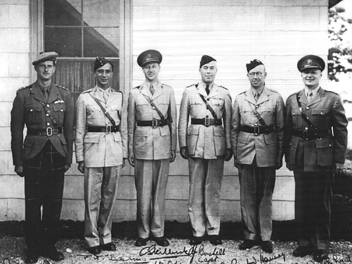 Major Paul Dehn (second from left) with other officers at Camp X, Britain’s secret spy-training school in Canada, c. 1943.